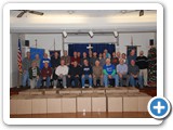 members take photo after packing boxes for needy family