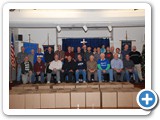 members take photo after packing boxes for needy family